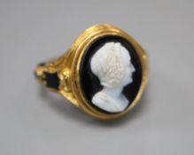 A Victorian 18ct gold cameo ring, of carved scrolled design with black enamelled decoration and