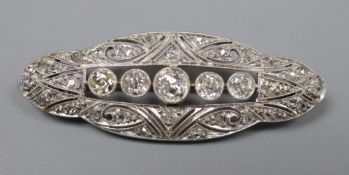 A 1920's pierced white metal and diamond set shaped oval brooch, 42mm, gross 5.8 grams.CONDITION: