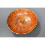 An orange glazed Wedgwood lustre dish, decorated with bird of paradise, diameter 9.5cm