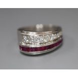 A stylish white metal (stamped Plat), graduated ruby and diamond set twin row dress ring, size O,