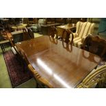 A reproduction mahogany twin pillar extending dining table and eight George I style chairs, 300cm