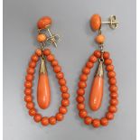 A pair of 9ct mounted coral bead earrings of open teardrop form, overall 51mm, gross 9 grams.