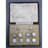 A cased mid 20th century 9ct & 18ct, mother of pearl and seed pearl set eight piece octagonal