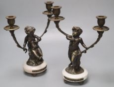 A pair of bronzed-finished metal figural candelabra, on circular bases, height 31cm