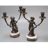 A pair of bronzed-finished metal figural candelabra, on circular bases, height 31cm