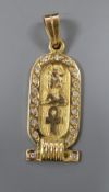 An Egyptian yellow metal and diamond set hieroglyphics pendant, 27mm, gross 4.3 grams.