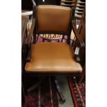 A Reprodux mahogany and tan leather swivel desk chair