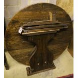 An oak circular table raised on lyre supports, diameter 110cm, height 73cm