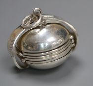 A modern 925 metamorphic hinged sphere pendant, opening to reveal four miniature photograph