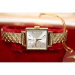 A lady's 9ct gold Longines manual wind square dial wrist watch, on 9ct bracelet, with Longines