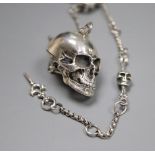 A sterling novelty skull locket?, on a skeletal albert chain, 32.5cm, gross 54 grams.