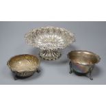 A pierced and embossed silver footed bowl, maker C.C, Chester 1907 and two silver sugar bowls, one