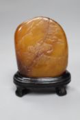 A Chinese amber coloured soapstone seal, late 19th / early 20th century, wood stand, overall