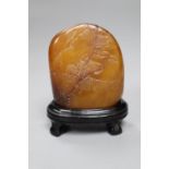 A Chinese amber coloured soapstone seal, late 19th / early 20th century, wood stand, overall
