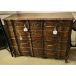 A 20th century French oak commode, fitted four long drawers with carved decoration, width 122cm,