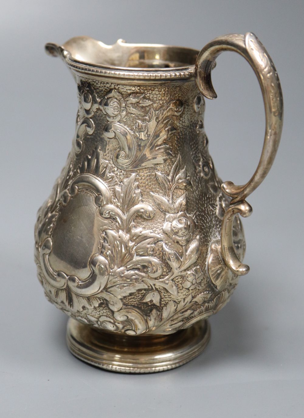 A Victorian embossed silver milk jug, Sheffield, 1860 and a silver salver, London, 1857, 27.5cm, - Image 5 of 6