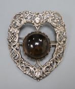 A large late Victorian pierced silver and cabochon quartz? set shield shaped brooch, 81mm.