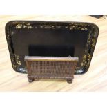 A large papier mache gilt-decorated tray and a 1930's carved oak Canterbury, with double rattan