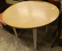 A contemporary circular oak dining table, 110cm diameter