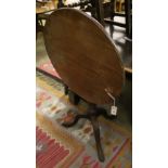 A George III circular mahogany tilt top tripod tea table, 68cm diameter