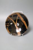 Attributed to Shoji Hamada (1894-1978). A shallow circular persimmon-glazed dish, diameter 18cm (