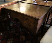 A George III oak low boy, with one long and two short drawers, with brass drop handles, on square