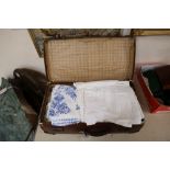 A quantity of mixed table linens in a suitcase