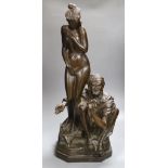 A large bronzed figure group of a seated male and nude female, indistinctly signed, 66cm