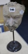 A life mask of a gentleman on stand