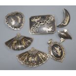 Five assorted Thai sterling and niello brooches, a pair of similar ear clips and a pendant.