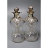 A pair of Edwardian pierced silver mounted waisted decanters, Henry Matthews, Birmingham, 1906,