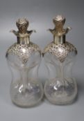 A pair of Edwardian pierced silver mounted waisted decanters, Henry Matthews, Birmingham, 1906,