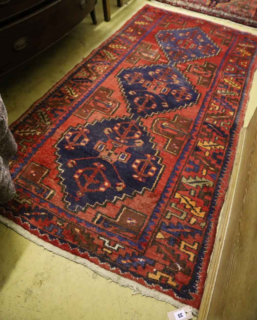 A Caucasian design red ground rug, 190 x 98cm