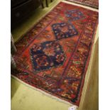 A Caucasian design red ground rug, 190 x 98cm
