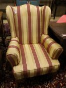 A 1920's wing armchair upholstered in striped fabric, width 80cm, depth 74cm, height 100cm