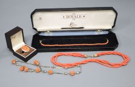 A white metal and carved coral set oval dress ring and three assorted necklaces.