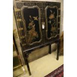 A Chinese black-lacquered and painted cabinet on stand, width 106cm, depth 46cm, height 173cm