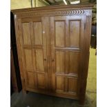 A carved and panelled oak and beech double wardrobe, width 120cm, depth 50cm, height 199cm