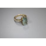 A modern 9ct gold, blue topaz and gem set dress ring, size N, gross 4 grams.