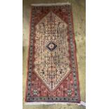 A Hamadan peach ground rug, 144 x 66cm
