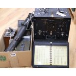 A collection of vintage military equipment, including a WWII British Tank Telescope Sight No. 33