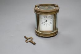 An oval brass carriage timepiece inscribed Elliott & Sons, London