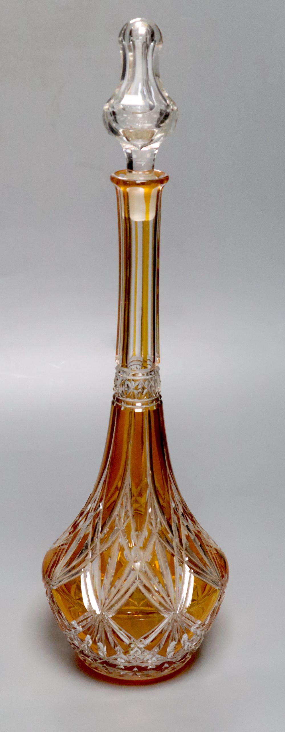 A tall amber-flashed glass decanter and clear stopper, height 48cm