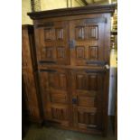 A French oak rustic-style panelled cupboard fitted upper and lower pairs of doors, width 122cm,