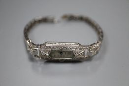 A lady's mid 20th century white metal (tests as platinum) and diamond set manual wind cocktail wrist