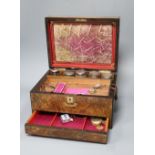 A walnut toilet box, containing four bottles and assorted badges and jewellery etc.