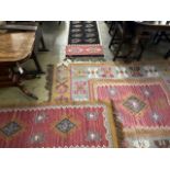 Three modern pink ground Kelim rugs, largest 200 x 155cm