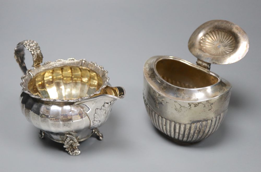 A George IV silver cream jug, London 1823 and an oval half-fluted tea caddy, William Hutton & Sons