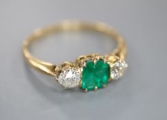 A yellow metal, emerald and diamond three stone ring, size Q, gross 2.3 grams.CONDITION: The emerald