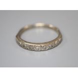 An 18ct white gold and nine stone diamond chip set half hoop eternity ring, size O, gross 2.6